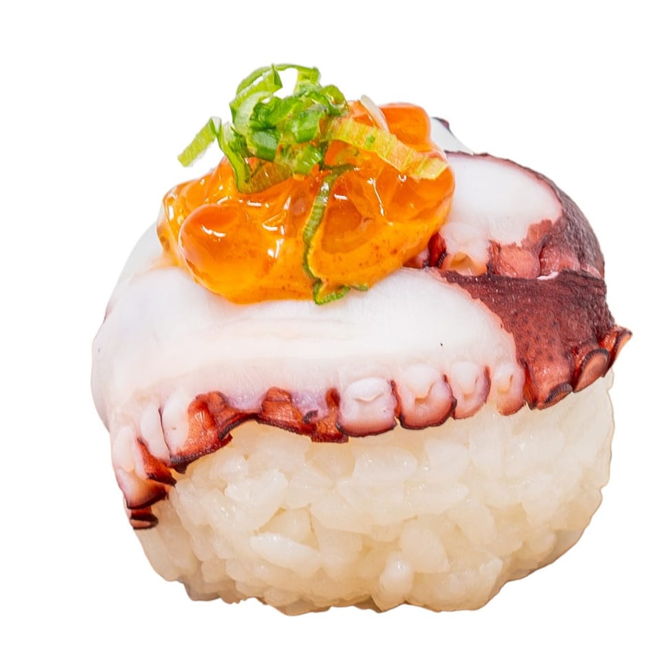 Octopus nigiri sushi with orange sauce and green onions on a white background.