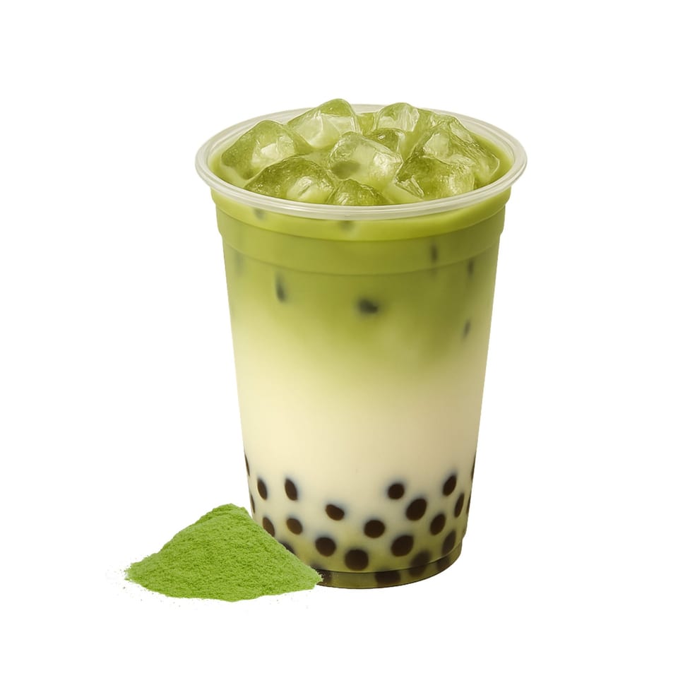 Iced matcha boba tea with a pile of matcha powder on a white background.