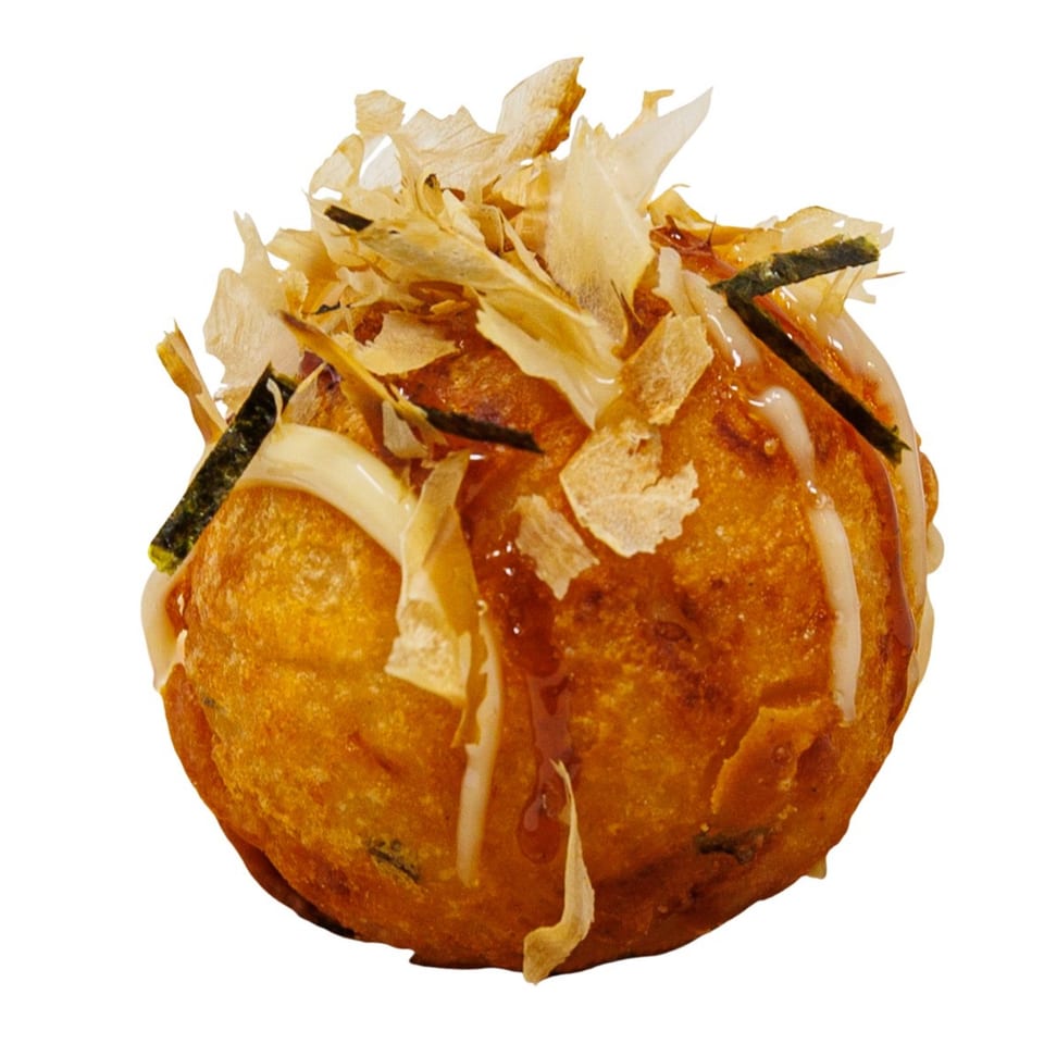 Golden-brown takoyaki topped with bonito flakes, nori, and white sauce, from Bloop Bloop sushi.